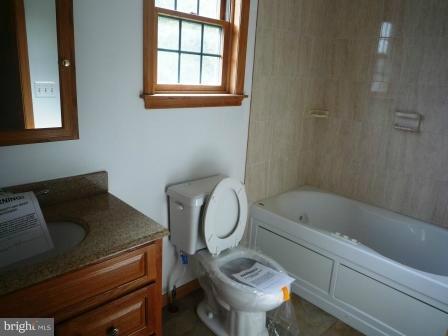 1302 Goose Neck Road Middle River, MD 21220 - Photo 8 of 29 a bathroom with a sink toilet and bathtub