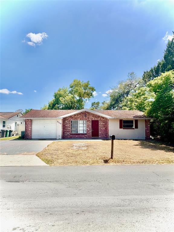 7734 Judith Crescent Port Richey, FL 34668 - Photo 1 of 1 a house with trees in front of it