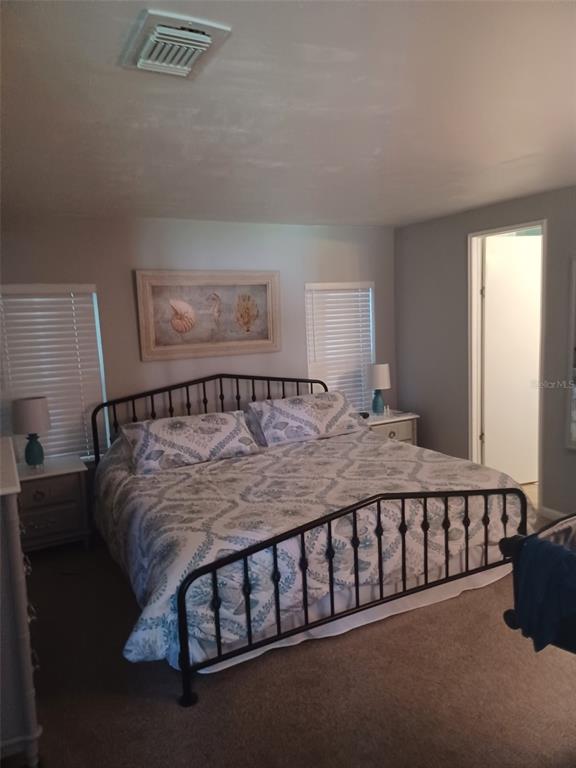 15550 Burnt Store Road, Unit 236 Punta Gorda, FL 33955 - Photo 5 of 6 a large bed sitting in a bedroom next to a window