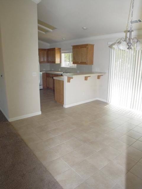 7764 Pit Road Redding, CA 96001 - Photo 3 of 8 a view of a kitchen with a sink cabinets and a window