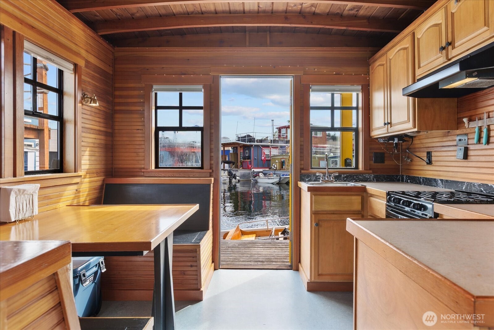 2401 North Northlake Way, Unit E7 Seattle, WA 98103 - Photo 3 of 23 a kitchen with a stove a refrigerator and wooden cabinets