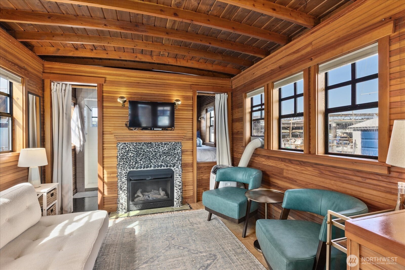 2401 North Northlake Way, Unit E7 Seattle, WA 98103 - Photo 5 of 23 a living room with furniture a fireplace and a table