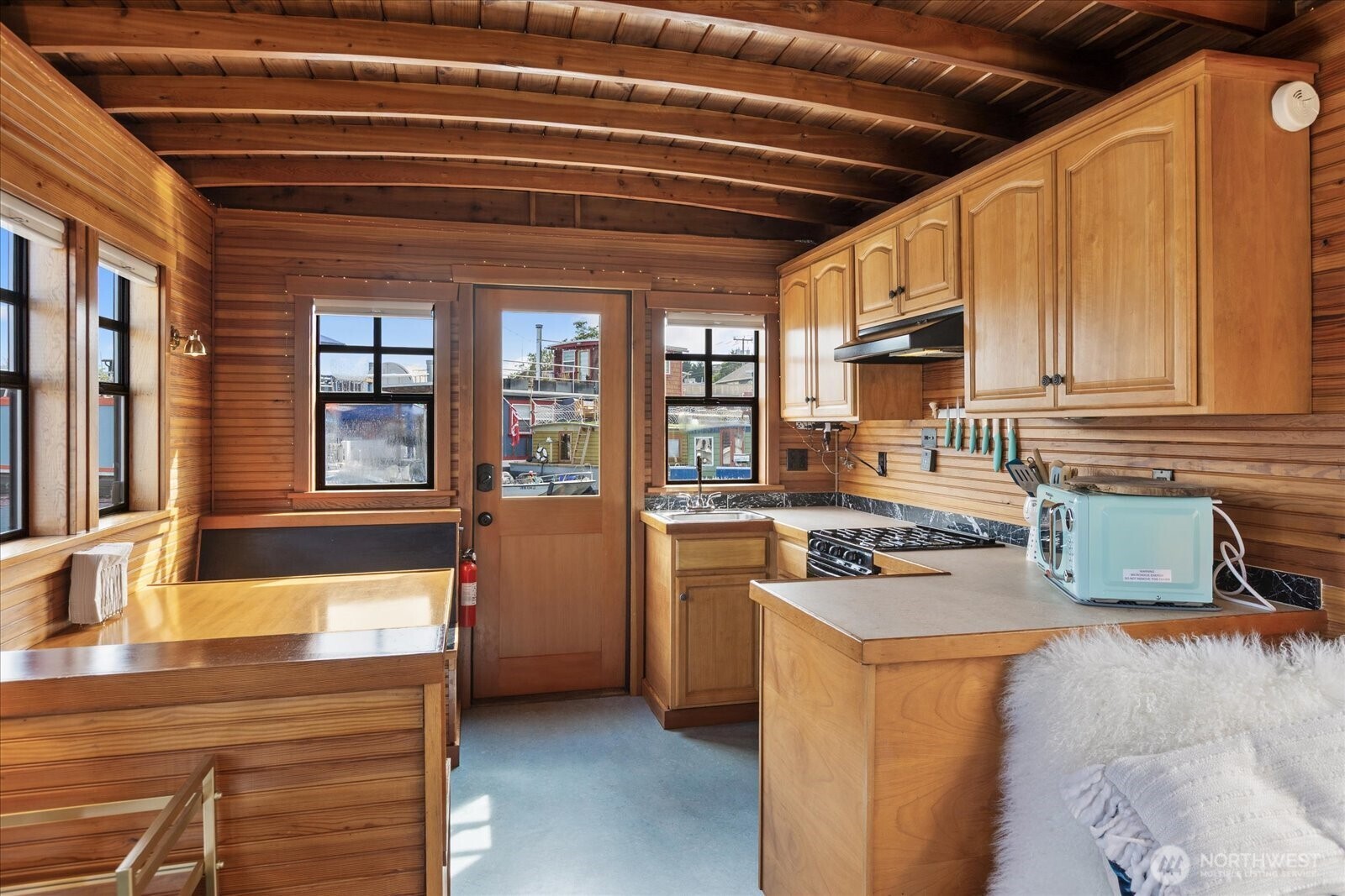 2401 North Northlake Way, Unit E7 Seattle, WA 98103 - Photo 8 of 23 a kitchen with stainless steel appliances granite countertop a stove and a refrigerator