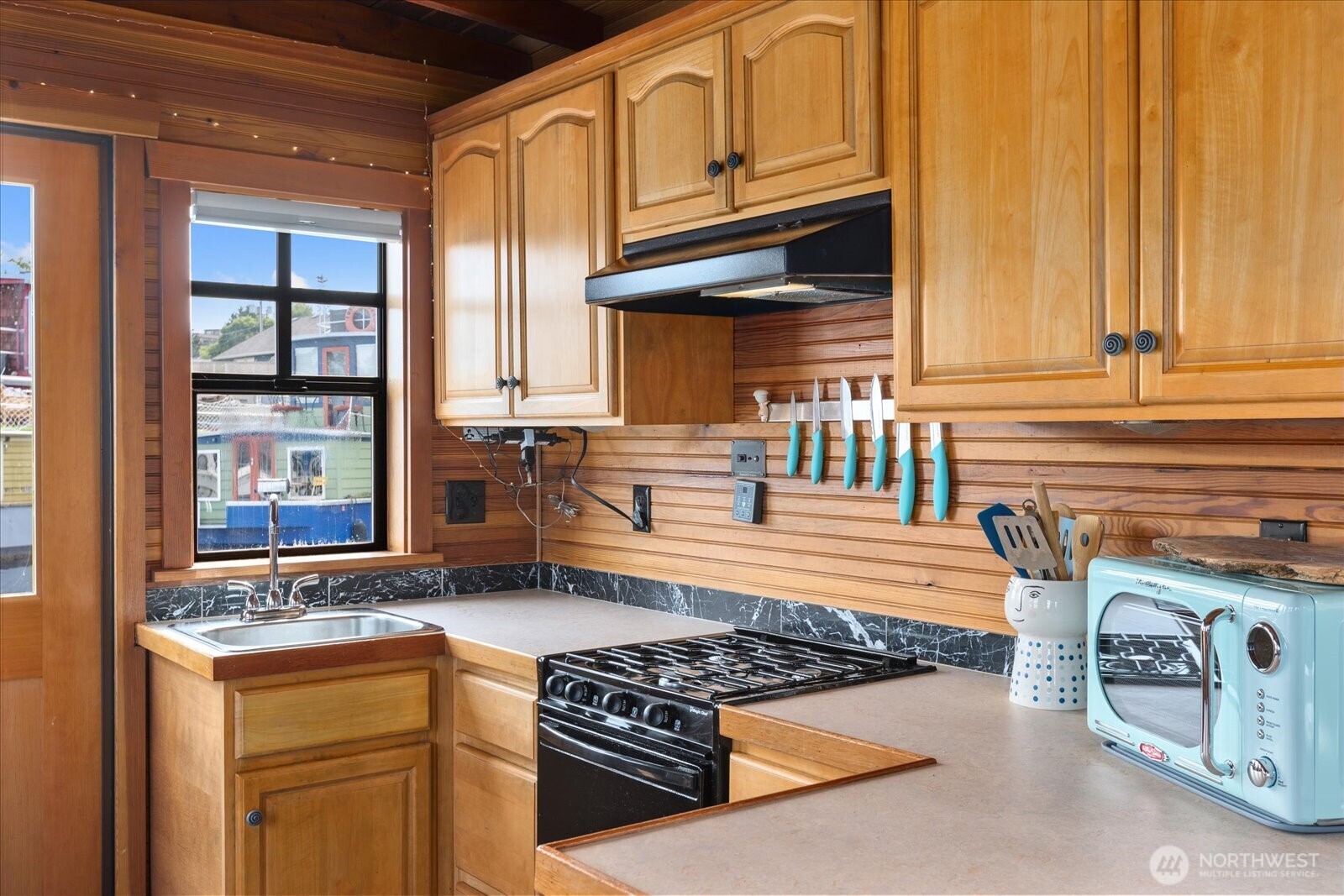 2401 North Northlake Way, Unit E7 Seattle, WA 98103 - Photo 9 of 23 a kitchen with stainless steel appliances granite countertop a sink stove and cabinets