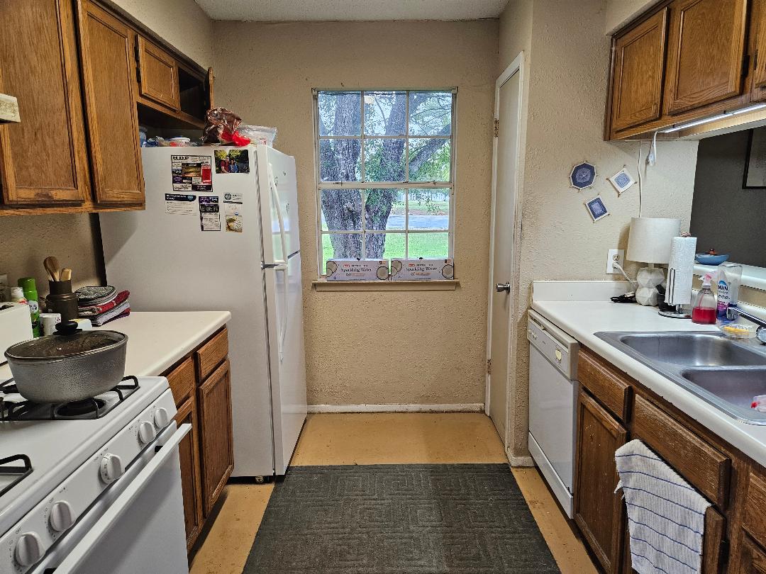 817 Lexington Road Elgin, TX 78621 - Photo 15 of 20 a kitchen with a sink stove and cabinets