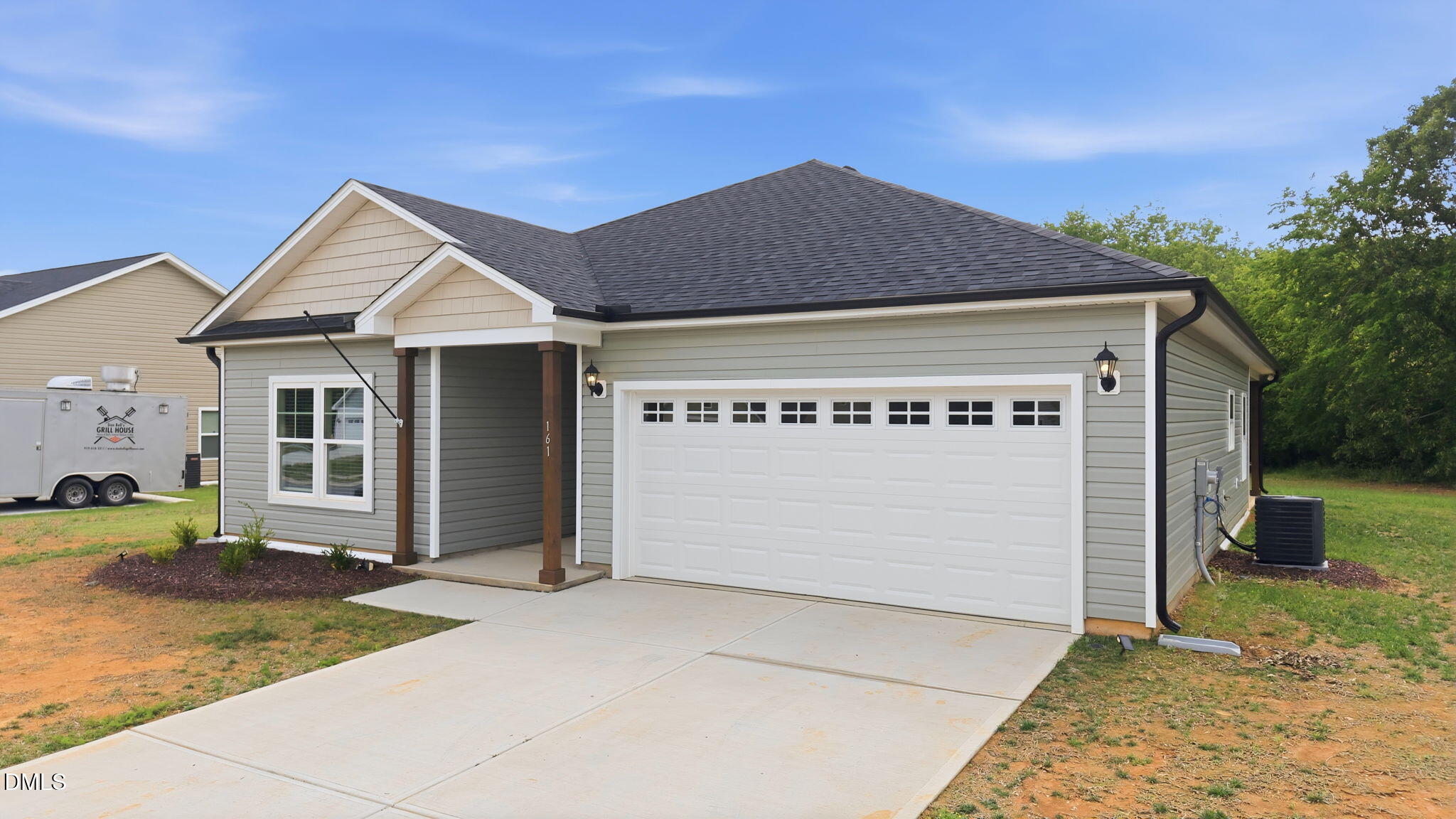 161 Tupelo Dr Spring Spring Hope, NC 27882 - Photo 4 of 28 a front view of a house with a yard and garage