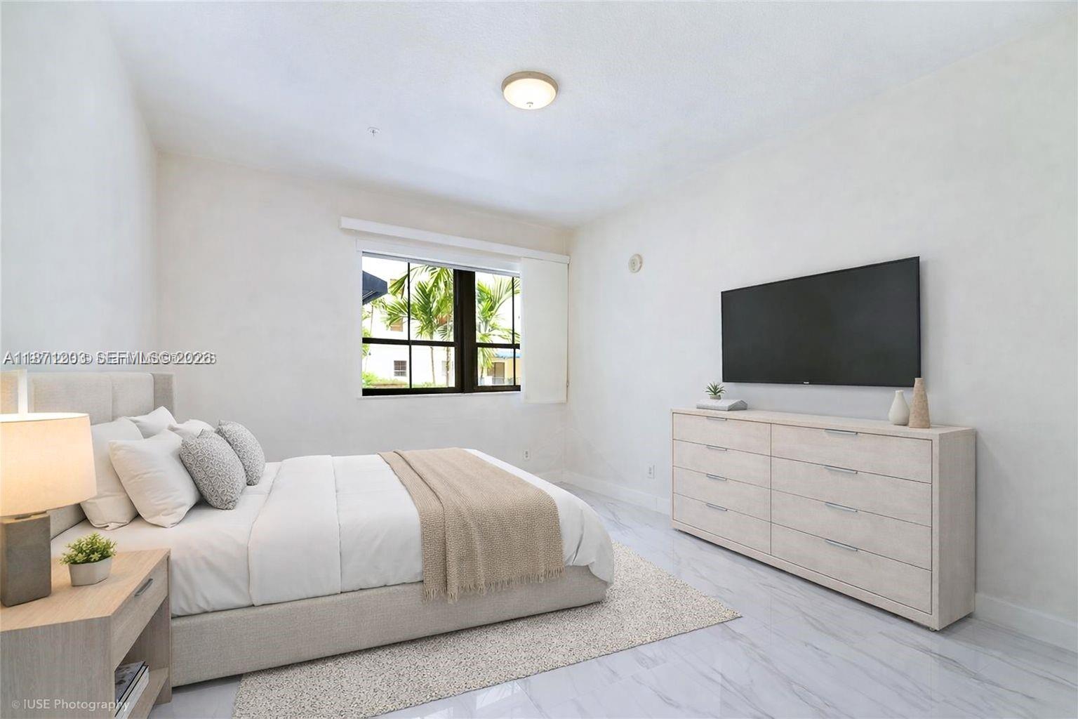 8395 Southwest 73rd Avenue, Unit 511 Miami, FL 33143 - Photo 7 of 18 a bedroom with a bed and a flat screen tv