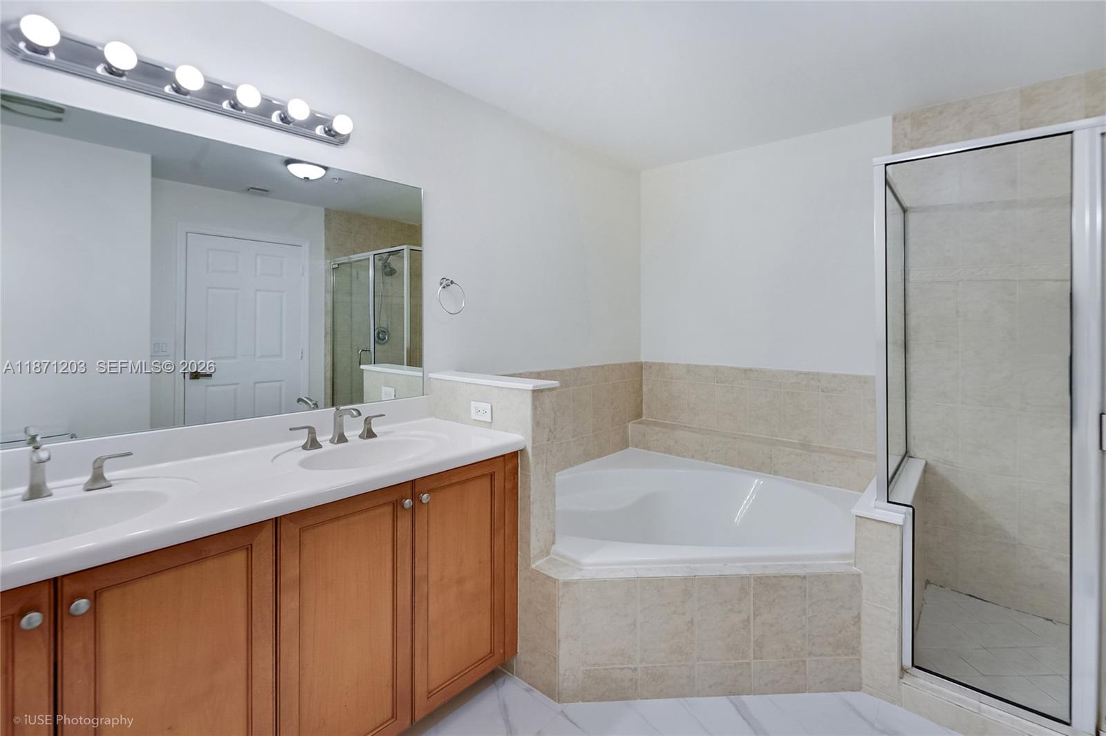 8395 Southwest 73rd Avenue, Unit 511 Miami, FL 33143 - Photo 9 of 18 a bathroom with a tub sink and mirror