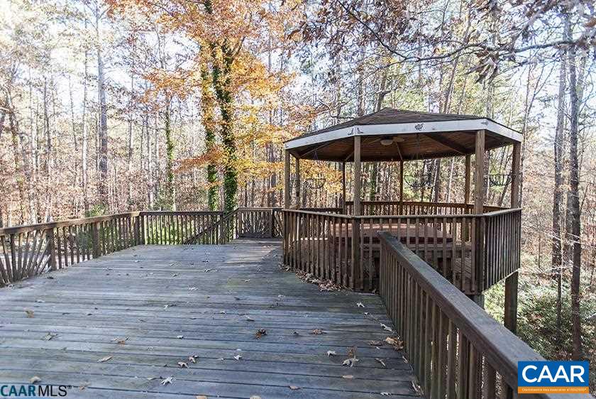 2355 Cinnamon Ridge Road Charlottesville, VA 22901 - Photo 4 of 36 a view of a deck with wooden floor and roof with a garden