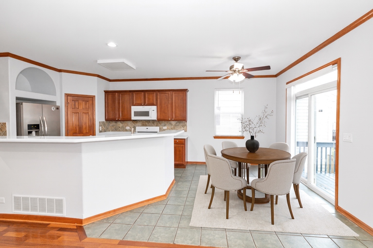 3311 Lafayette Street Elgin, IL 60124 - Photo 16 of 50 a kitchen with stainless steel appliances a dining table chairs and a refrigerator