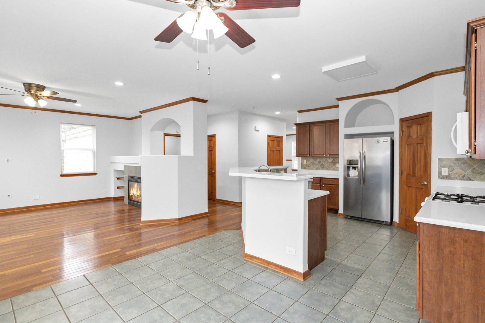 3311 Lafayette Street Elgin, IL 60124 - Photo 17 of 50 a kitchen with stainless steel appliances kitchen island granite countertop a refrigerator a stove top oven and white cabinets