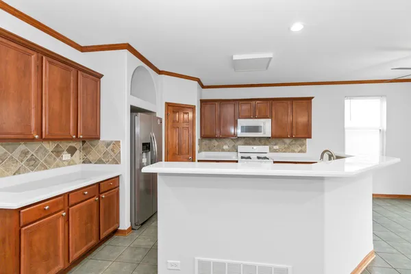 a kitchen with stainless steel appliances a sink and cabinets