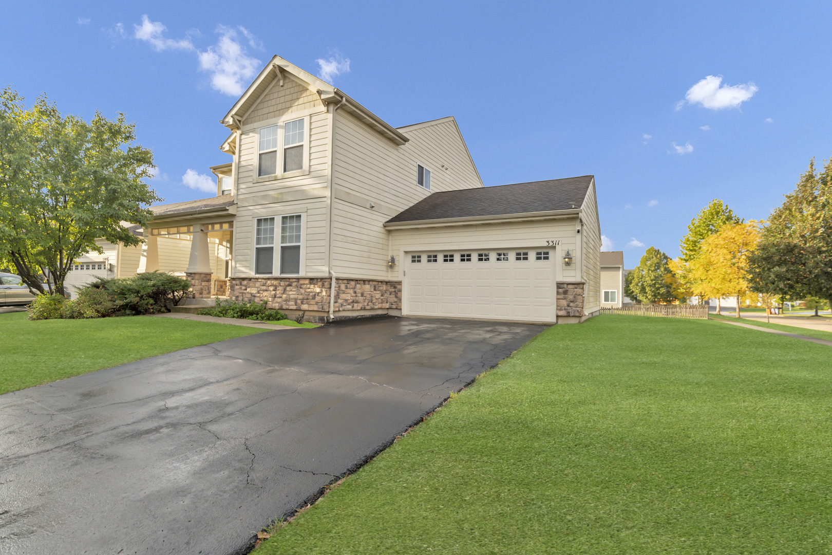 3311 Lafayette Street Elgin, IL 60124 - Photo 2 of 50 a front view of a house with a yard and garage