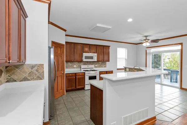 a kitchen with stainless steel appliances granite countertop a stove top oven
