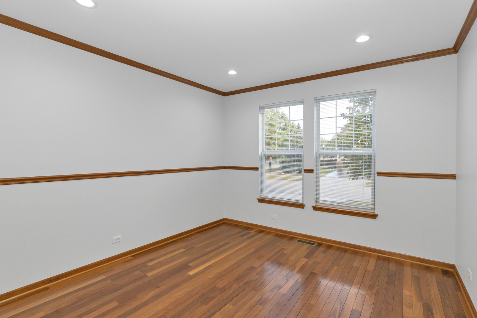 3311 Lafayette Street Elgin, IL 60124 - Photo 4 of 50 a view of empty room with wooden floor and fan