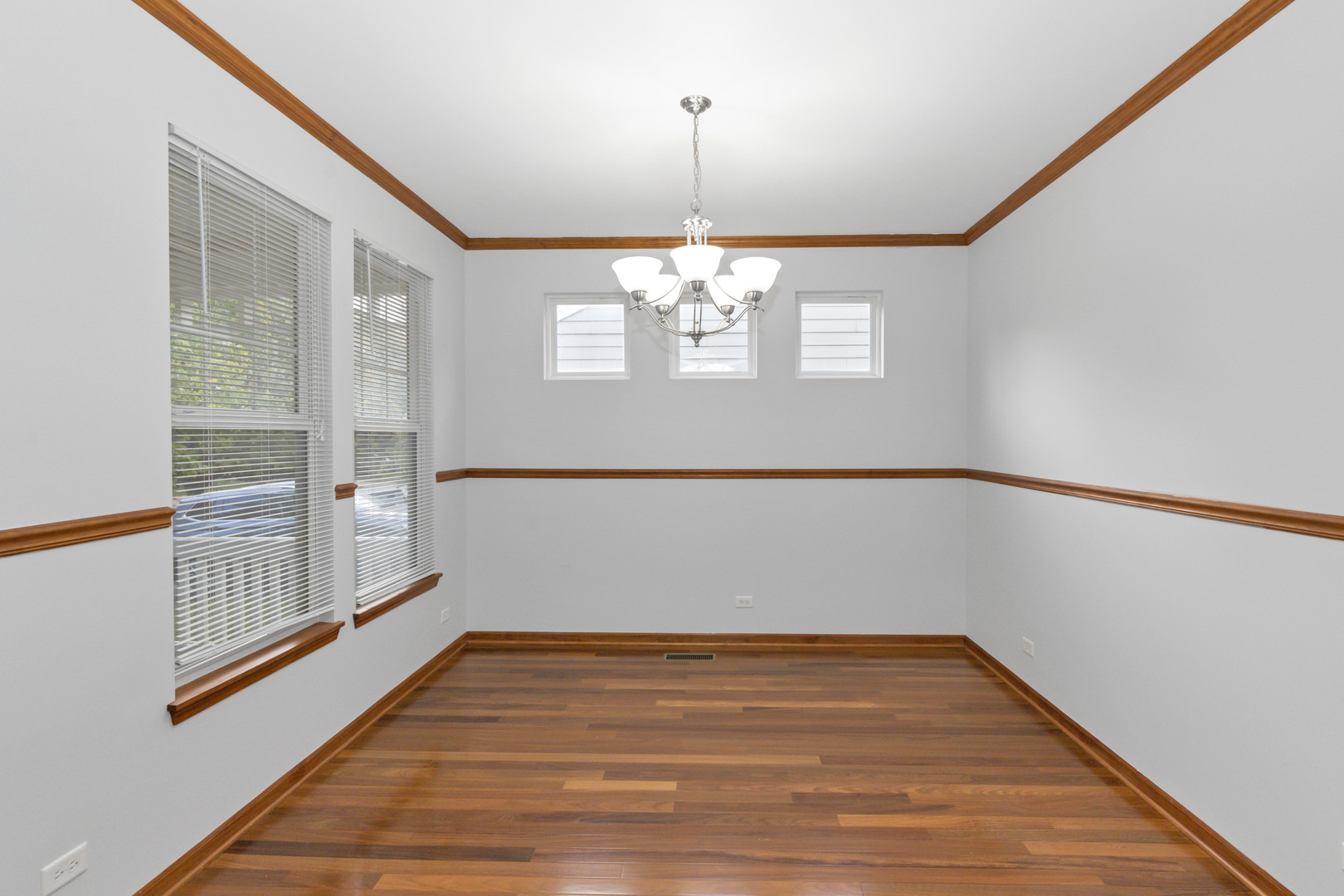 3311 Lafayette Street Elgin, IL 60124 - Photo 8 of 50 a view of a room with wooden floor and white walls