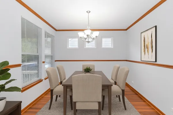 a view of a dining room with furniture and wooden floor