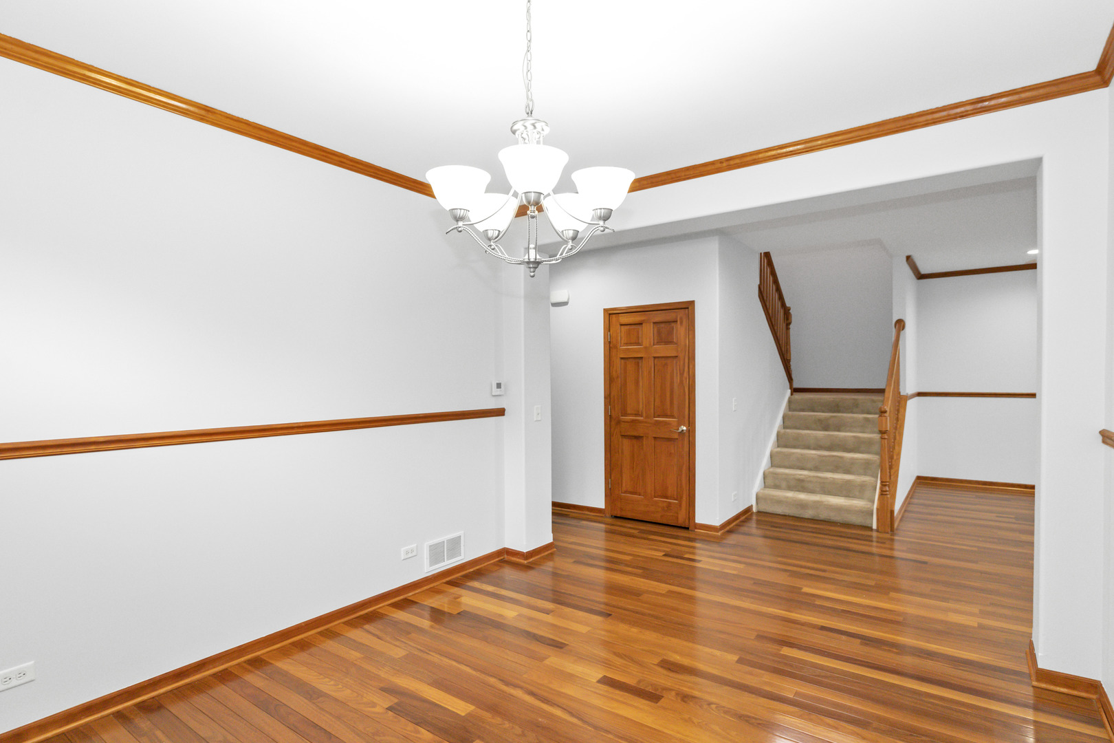 3311 Lafayette Street Elgin, IL 60124 - Photo 10 of 50 a view of an empty room with wooden floor and stairs