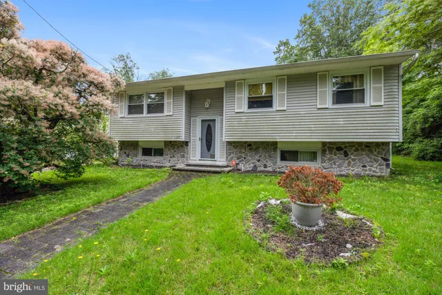 a backyard of a house with plants and outdoor seating
