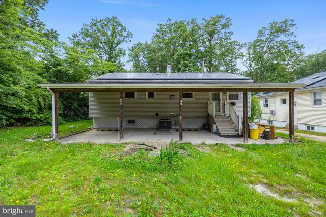 a view of a house with backyard porch and sitting area