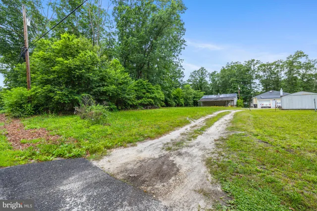 a view of a backyard with swimming pool