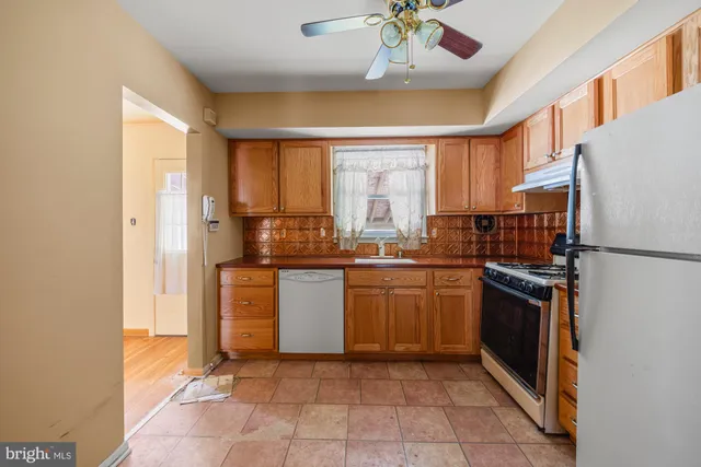 a kitchen with a refrigerator sink and stove