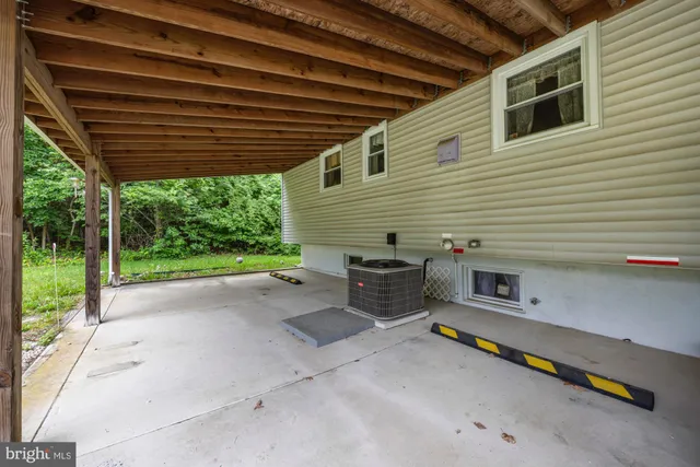 a backyard of a house with barbeque oven table and chairs