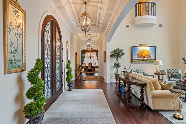 a view of a dining room with furniture and chandelier