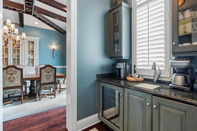 a view of a dining room with furniture a chandelier and wooden floor