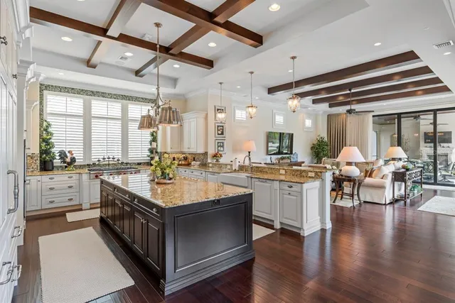 a bedroom with a large bed and a chandelier