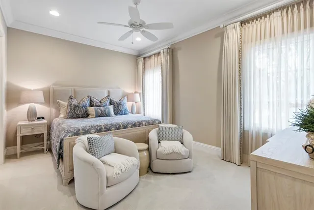 a living room with furniture and floor to ceiling window