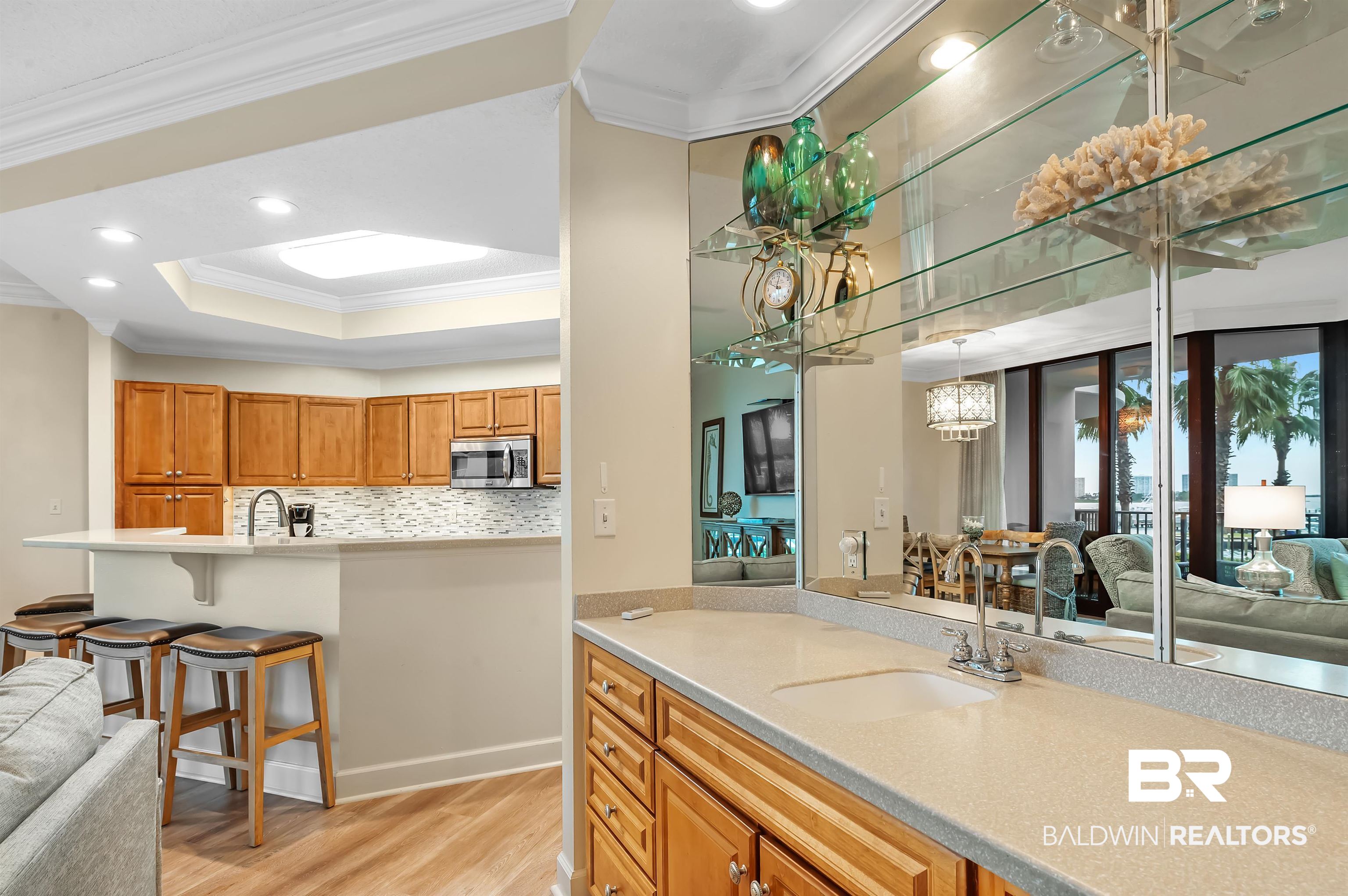 27582 Canal Road, Unit 2104 Orange Beach, AL 36561 - Photo 11 of 35 Kitchen featuring decorative backsplash, light hardwood / wood-style floors, crown molding, and sink