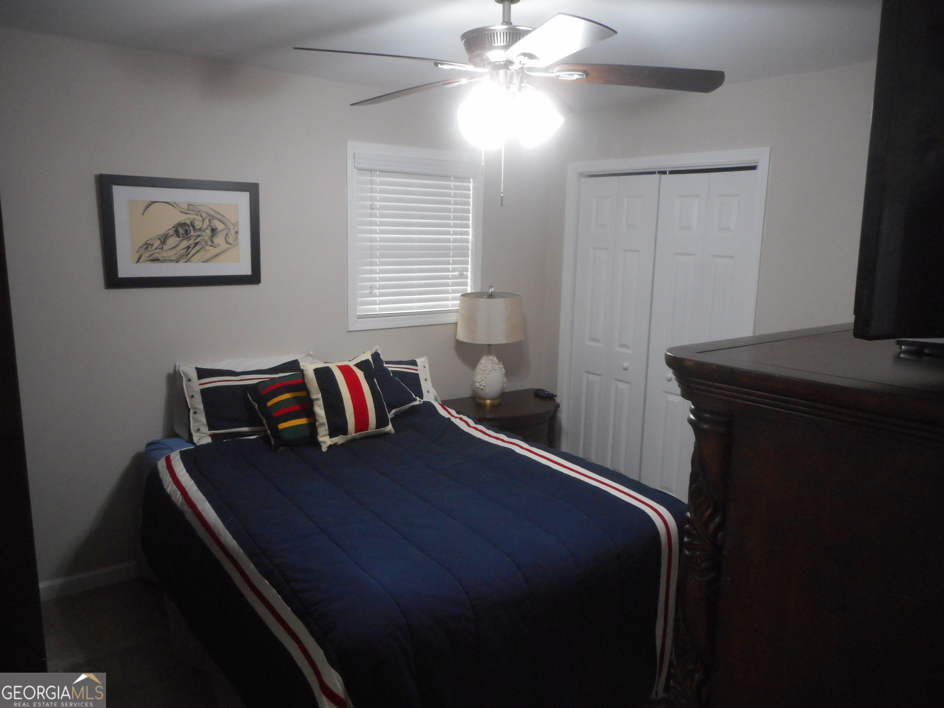 530 Grandview Avenue Mount Airy, GA 30563 - Photo 12 of 20 a bedroom with a bed and a flat tv screen on a dresser