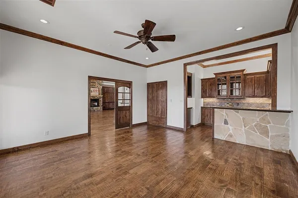 a view of empty room with wooden floor and window