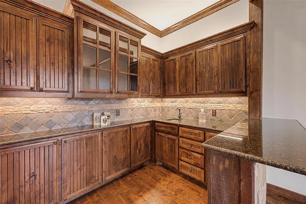 a kitchen with stainless steel appliances granite countertop wooden cabinets a sink and dishwasher