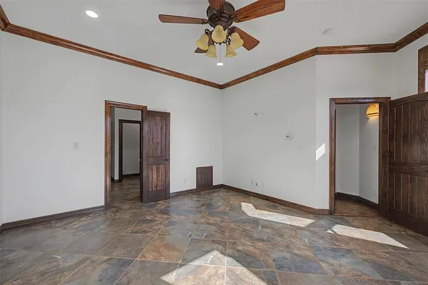 a view of a hallway with a chandelier fan