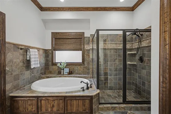 a bathroom with a bathtub and shower