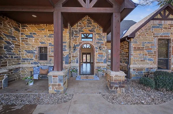 a front view of a house with outdoor seating