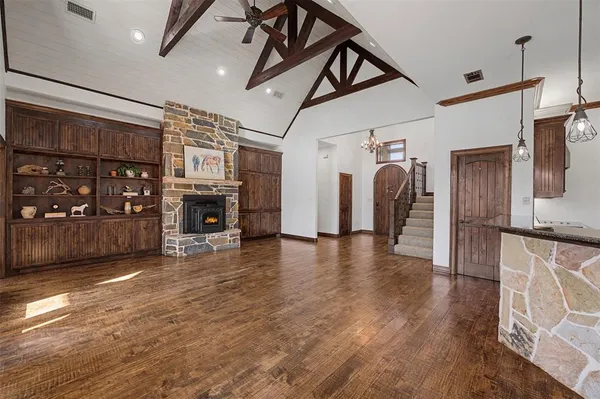 a view of a livingroom with furniture wooden floor and a ceiling fan