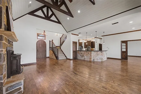 a view of a livingroom with furniture wooden floor and a ceiling fan
