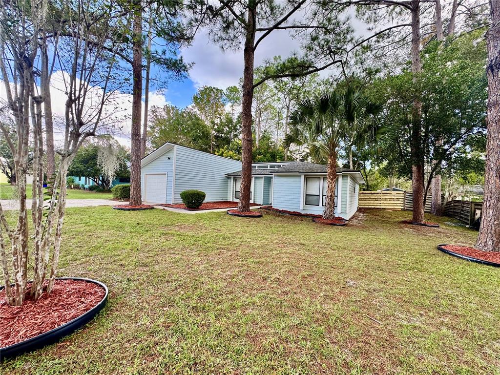 5407 Southwest 82 Terrace Gainesville, FL 32608 - Photo 3 of 31 a white house that has a tree in front of it