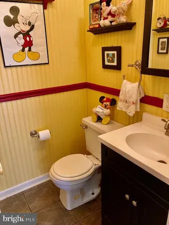 a bathroom with a toilet a sink and mirror