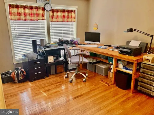 a view of a workspace with furniture and a window