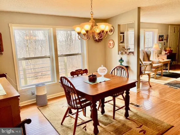 a view of a dining room with furniture and a chandelier