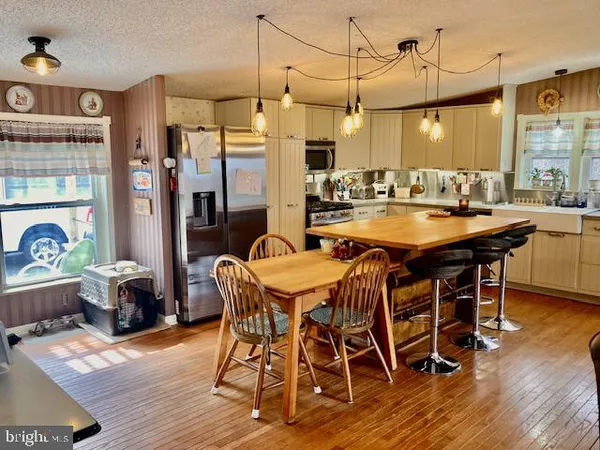 a dining table with chairs and wooden floor