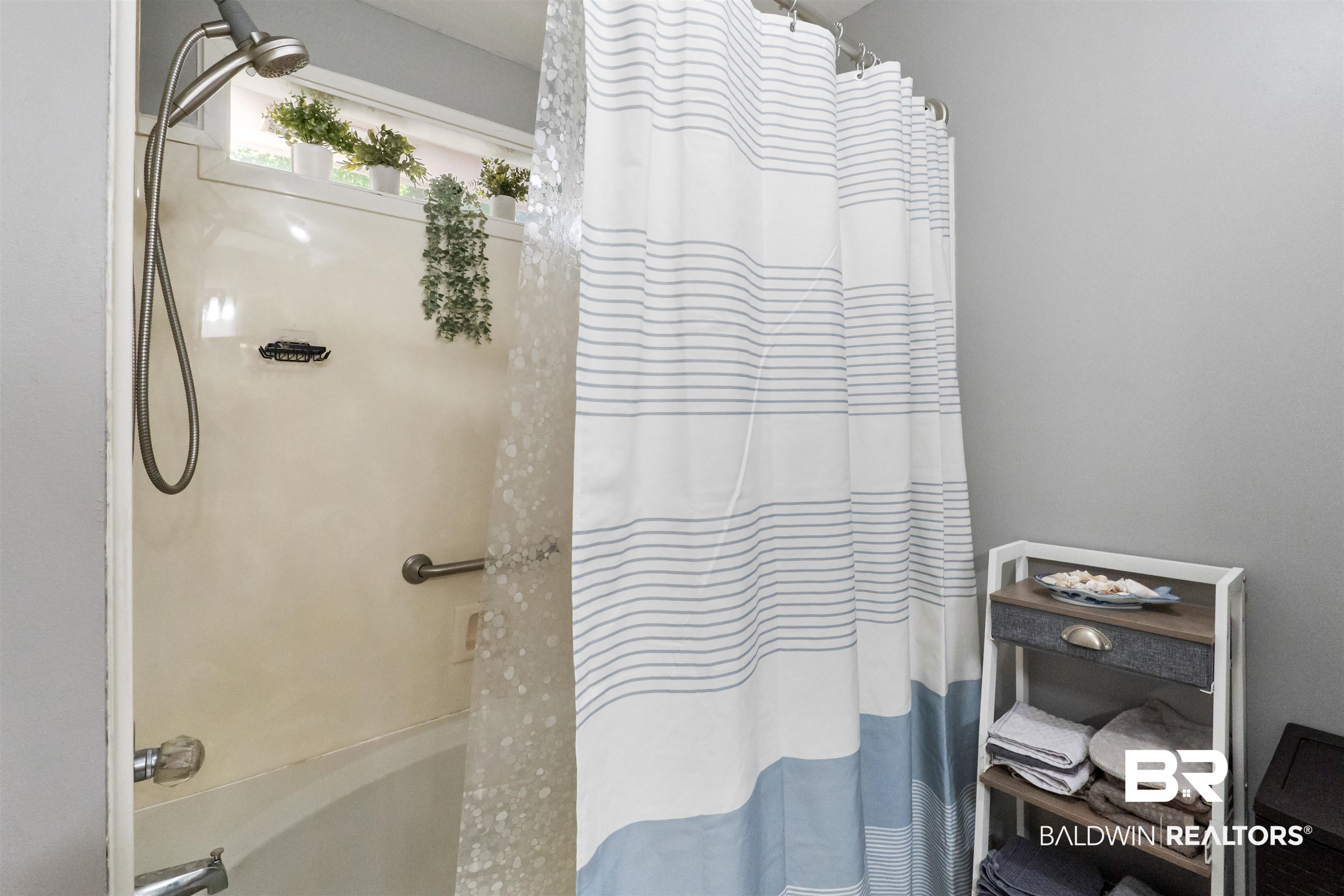 153 Lakeview Loop Daphne, AL 36526 - Photo 37 of 56 The tub and shower combination creates a comfortable space to unwind and prepare for the day ahead.