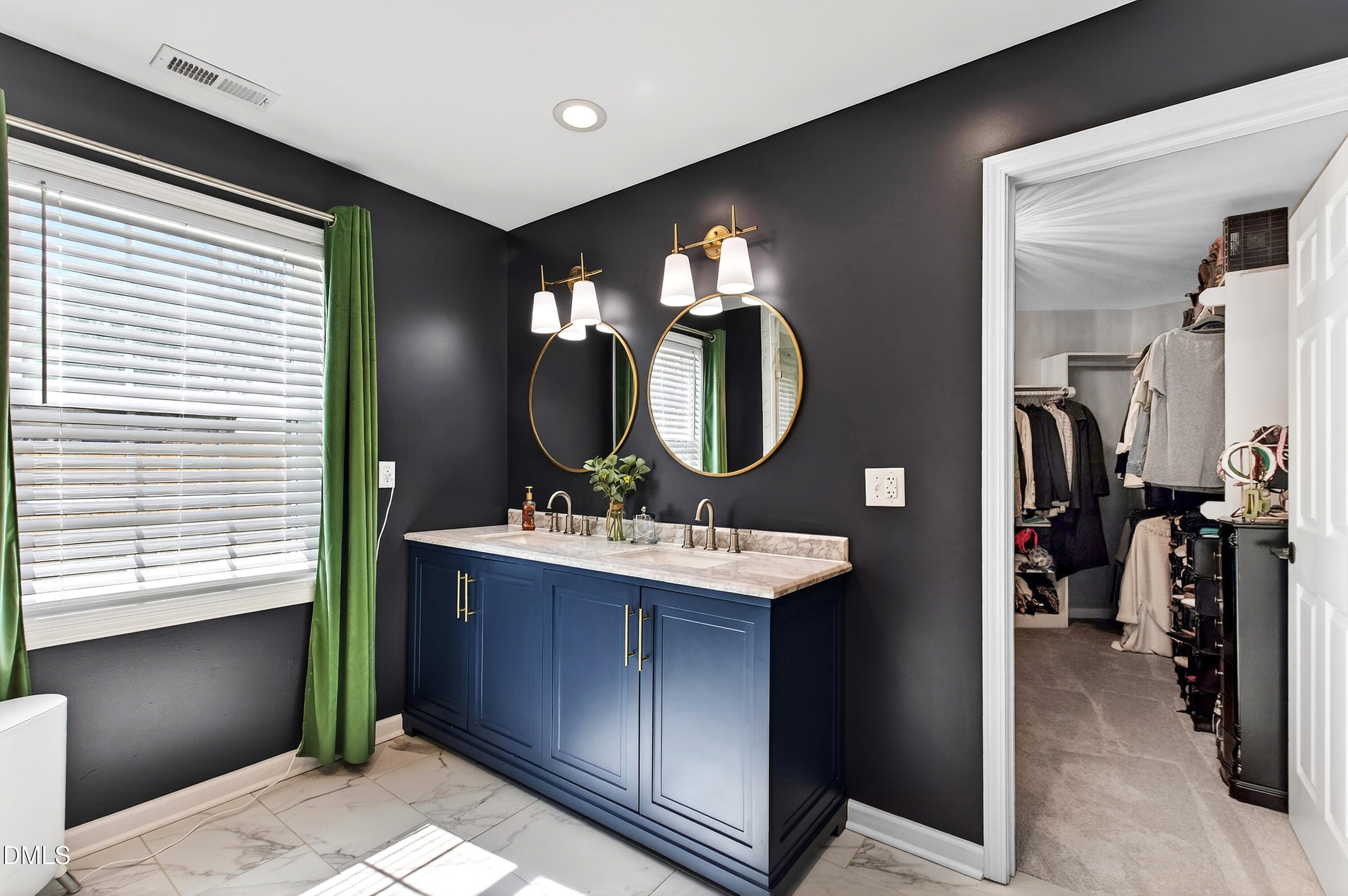 605 Chatham Lane Raleigh, NC 27610 - Photo 23 of 40 a bathroom with a double vanity sink and a mirror