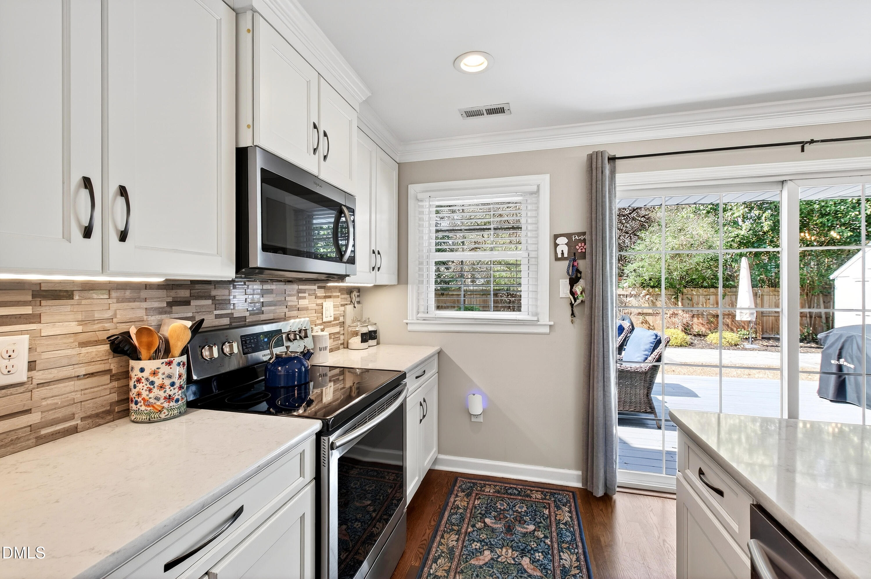 605 Chatham Lane Raleigh, NC 27610 - Photo 9 of 40 a kitchen with stainless steel appliances granite countertop a stove a sink and a microwave