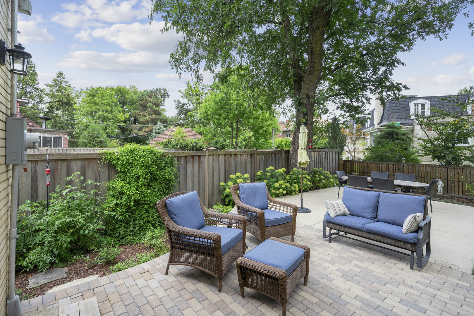 600 East Parkway Road Riverside, IL 60546 - Photo 20 of 29 a view of a patio with couches and a table and chairs with plants and trees