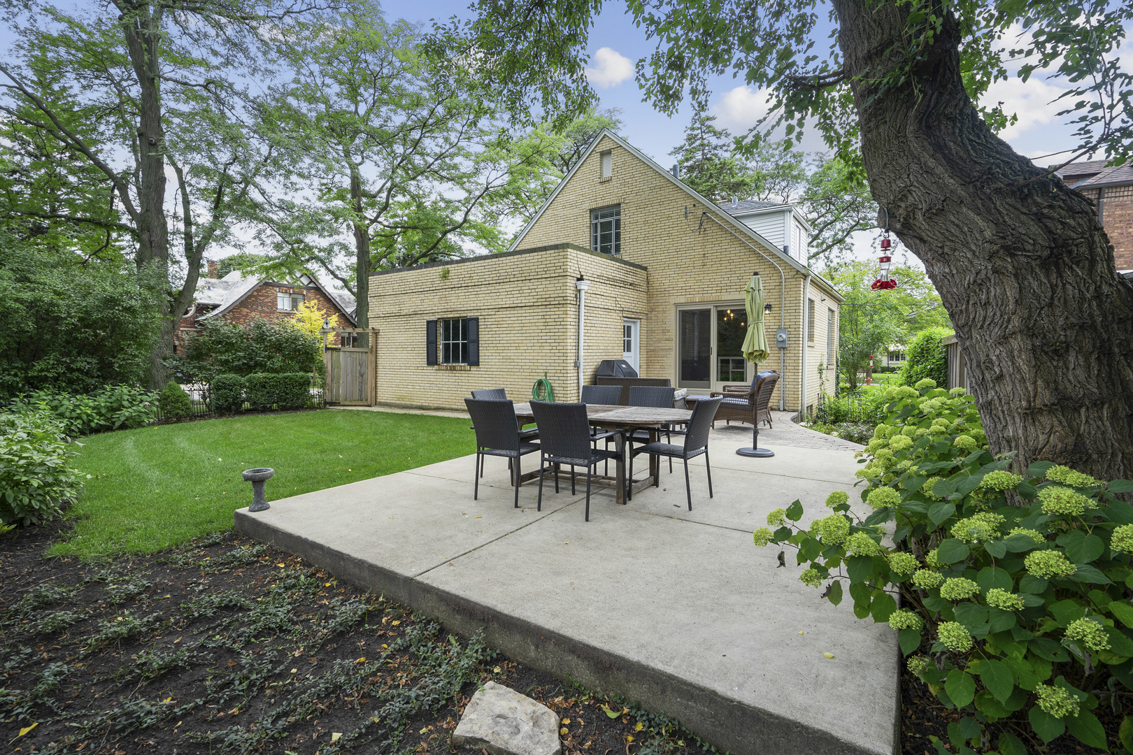 600 East Parkway Road Riverside, IL 60546 - Photo 22 of 29 a view of a house with patio and a yard